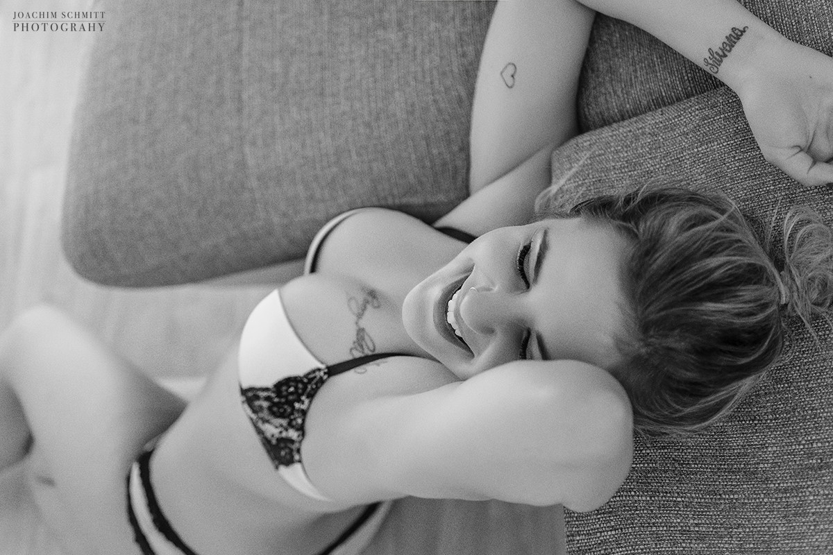 Eine Frau in Dessous, die auf einem Sofa liegt.